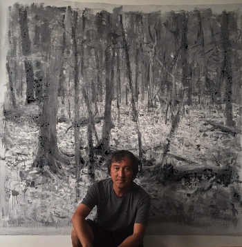 Quang Ho in front of large painting